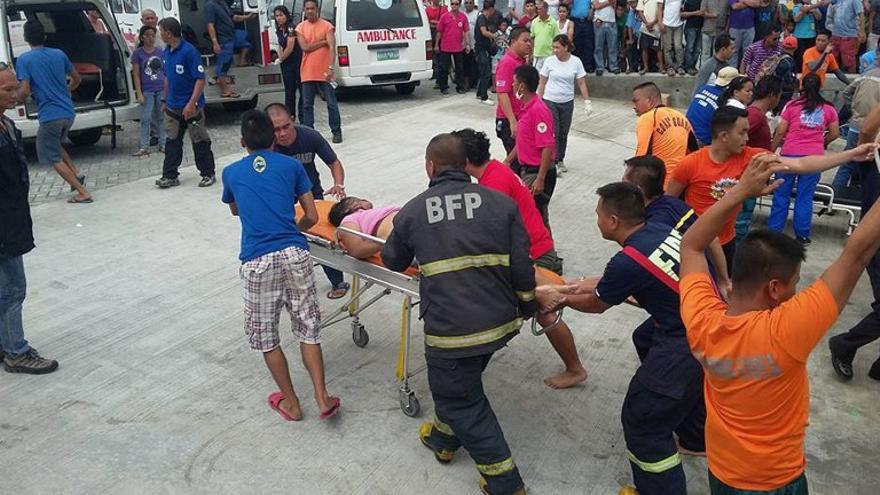 Sobrevivientes de un ferry de pasajeros que se hundió en aguas turbulentas lloran después de llegar al muelle en Ormoc City, centro de Filipinas