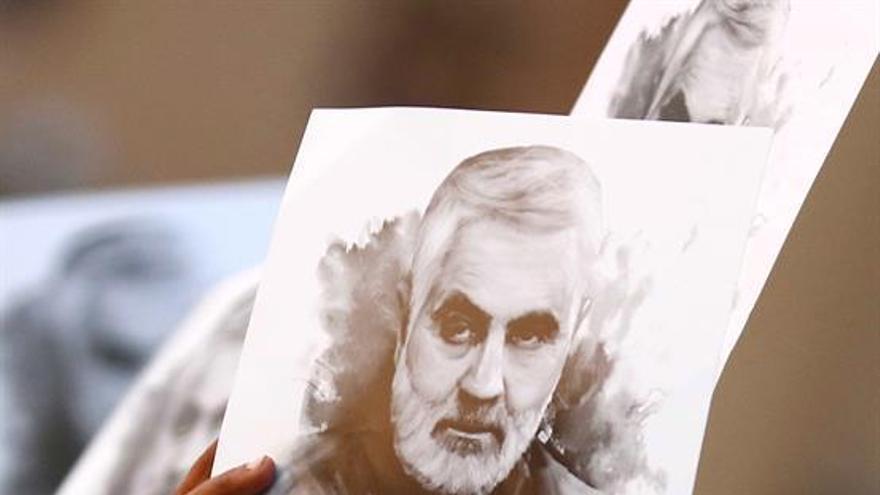 Una persona sostiene una imagen del general Soleimaní