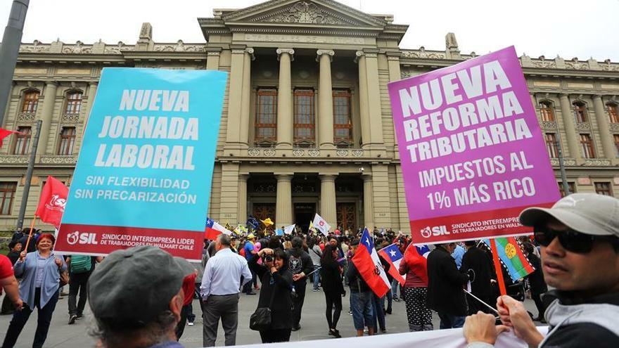 Personas se manifiestan este lunes en las afueras de la sede del Congreso Nacional, en Santiago (Chile)